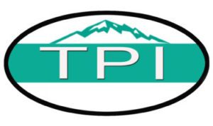 Logo featuring the letters "TPI" in white on a teal background, framed by an oval. Above the letters, a stylized white mountain range is depicted
