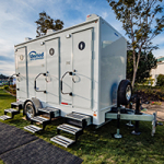 a mobile bathroom trailer setup in a park