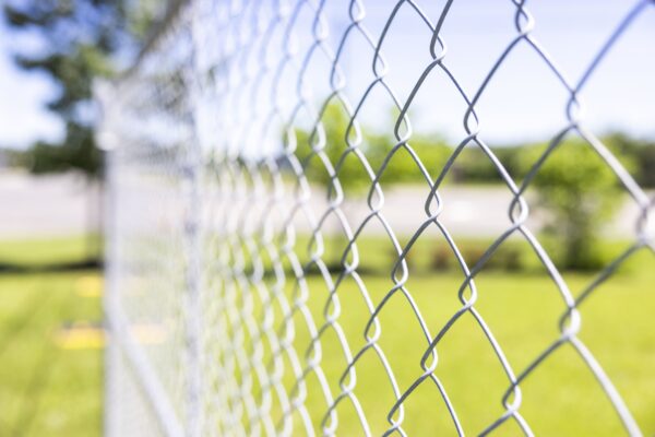 A temporary chain-link fence in a park