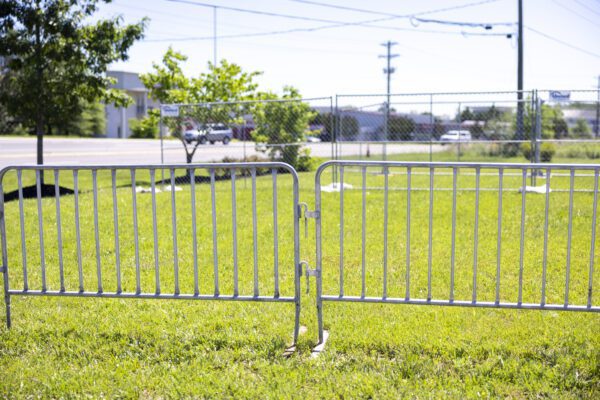 temporary barricades and temporary chain link fencing assembled for an outdoor event