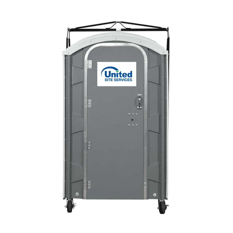A gray portable toilet with a crane hook featuring a white "United Site Services" logo on the top front, black handles, and black wheels