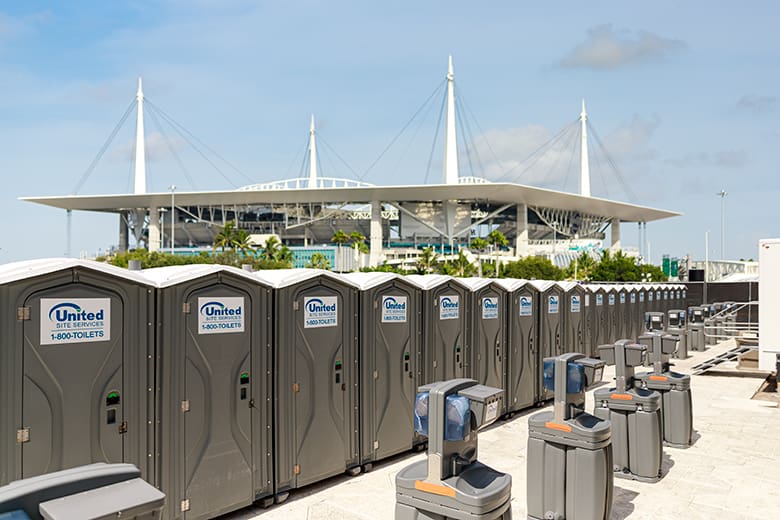 rows and rows of porta potties and hand washing stations outside an sport stadium rows and rows of porta potties and hand washing stations outside an sport stadium