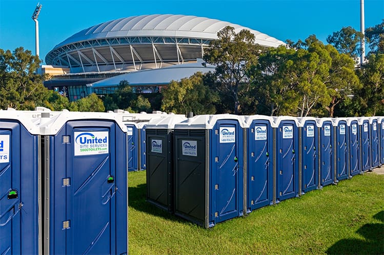 rows and rows of porta potties outside an sport stadium