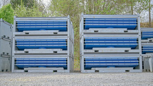 Hydroflow urinal pallets waiting for installation on gravel with trees in the background